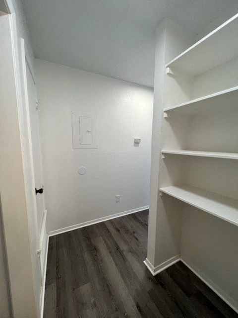 a room with white shelves and a wall with stripes on it