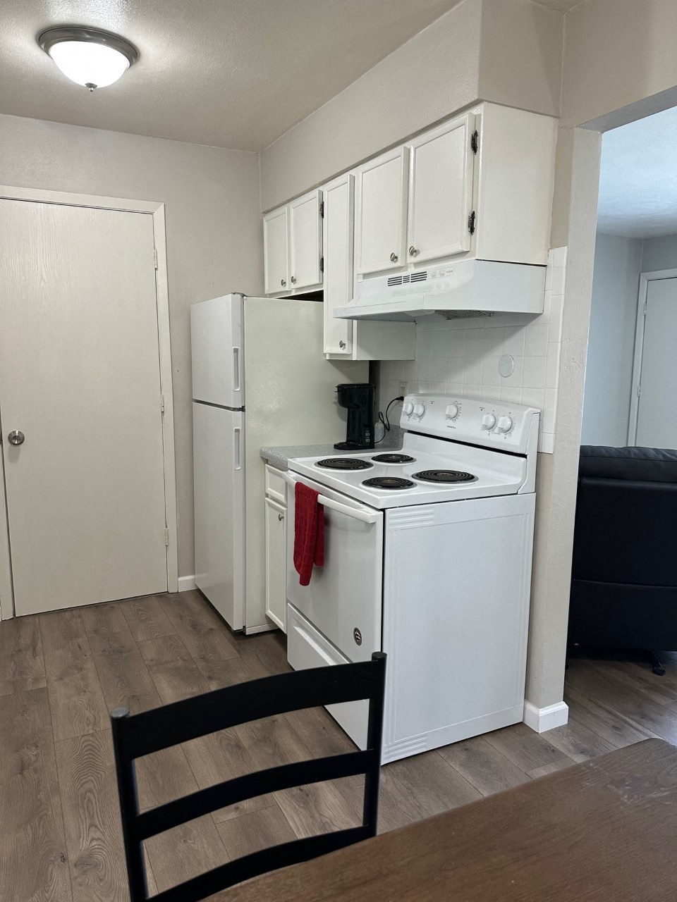 a kitchen with white appliances and a refrigerator and a stove at shiloh commons belleville