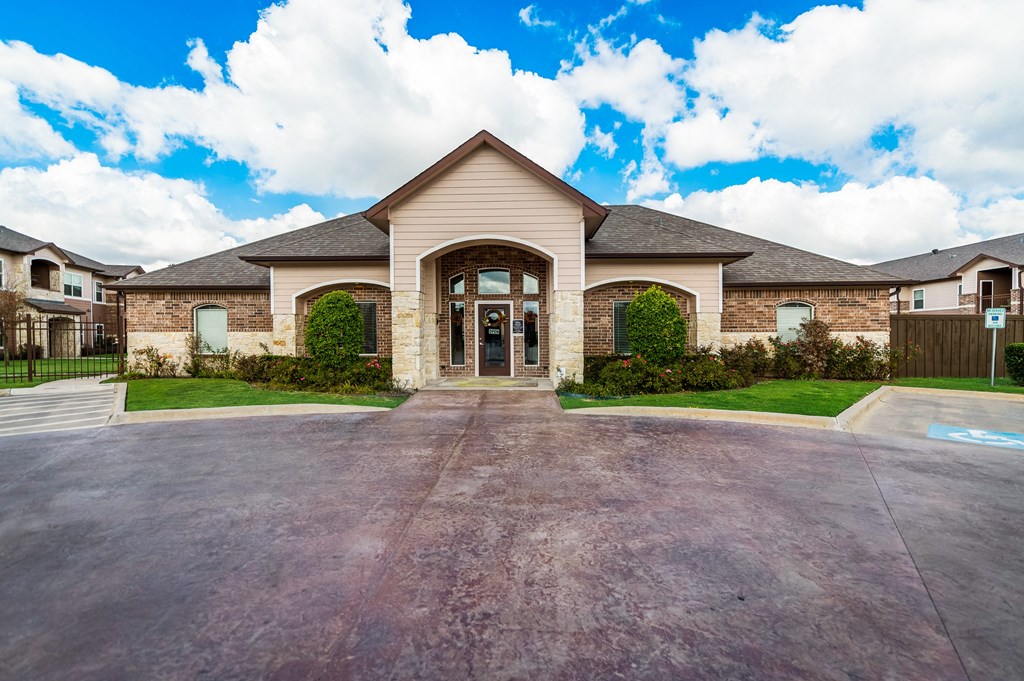 the front of a house with a driveway and a garage door