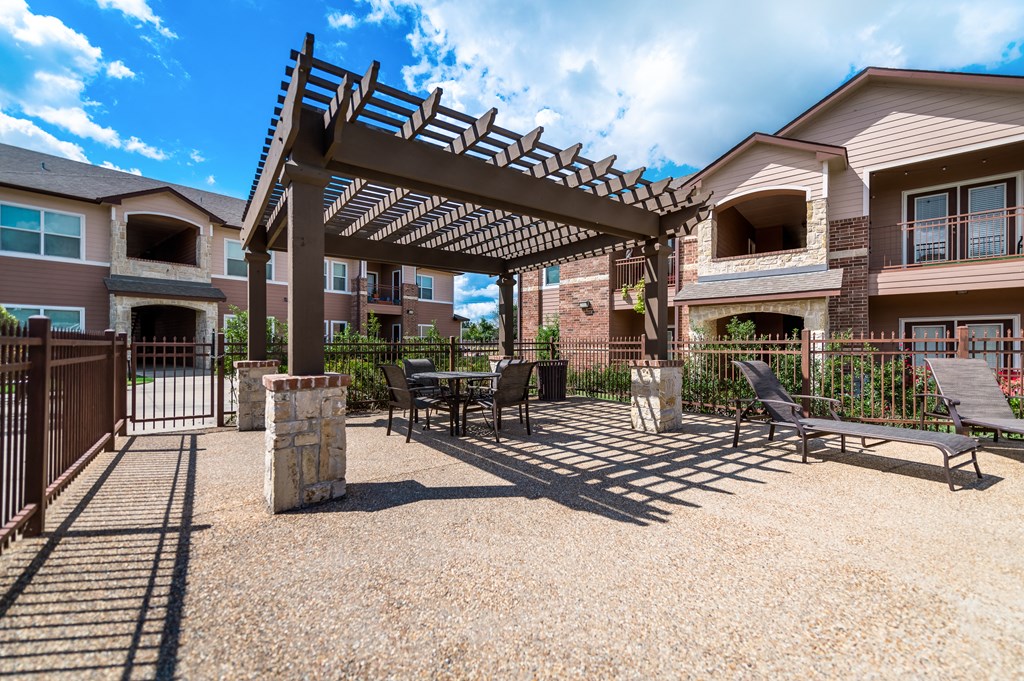 our apartments have a patio with a pergola and tables