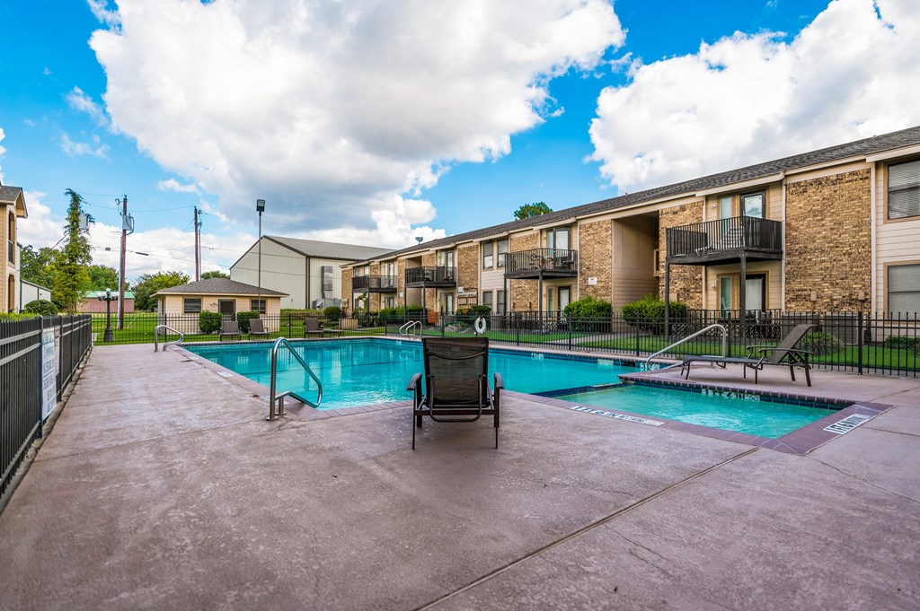 a swimming pool with a chair the corners apartments