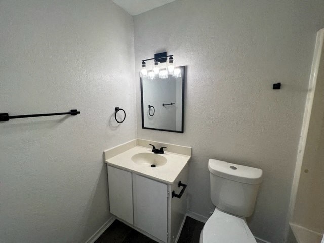a bathroom with a toilet and a sink and a mirror