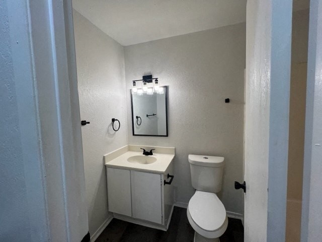 a bathroom with a toilet and a sink and a mirror