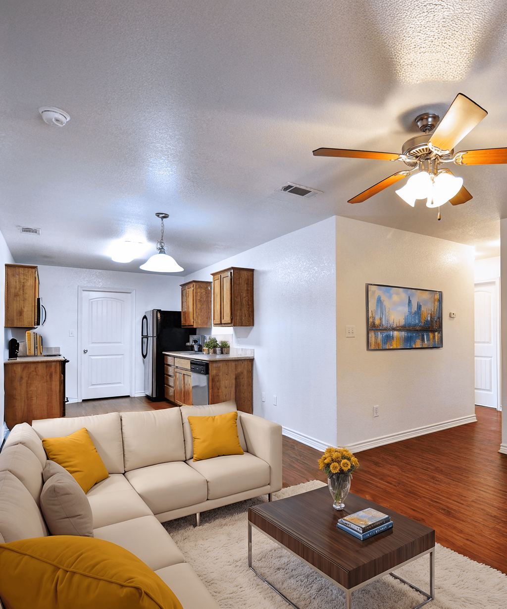 A living room with a white couch and a ceiling fan.