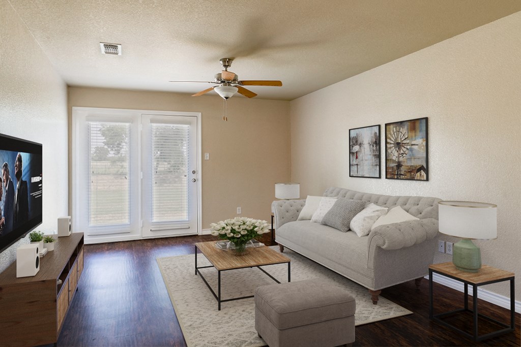 a living room with a couch and a ceiling fan