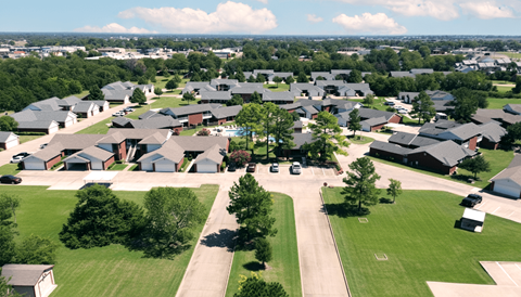 A suburban neighborhood with houses and green lawns.