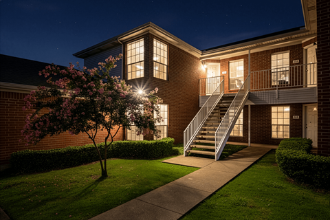 A building with a lit up staircase and windows.