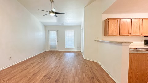 A room with wooden flooring and a ceiling fan.