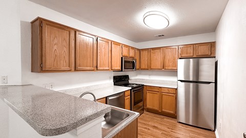 A kitchen with wooden cabinets and stainless steel appliances.