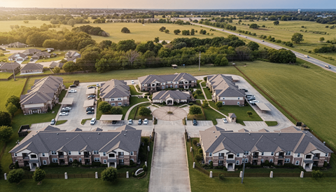 A bird's eye view of a residential area with houses and greenery.
