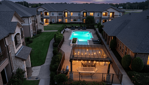A swimming pool in a backyard surrounded by houses.