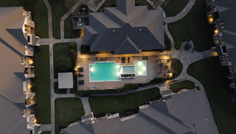 An aerial view of a building with a pool in the middle.