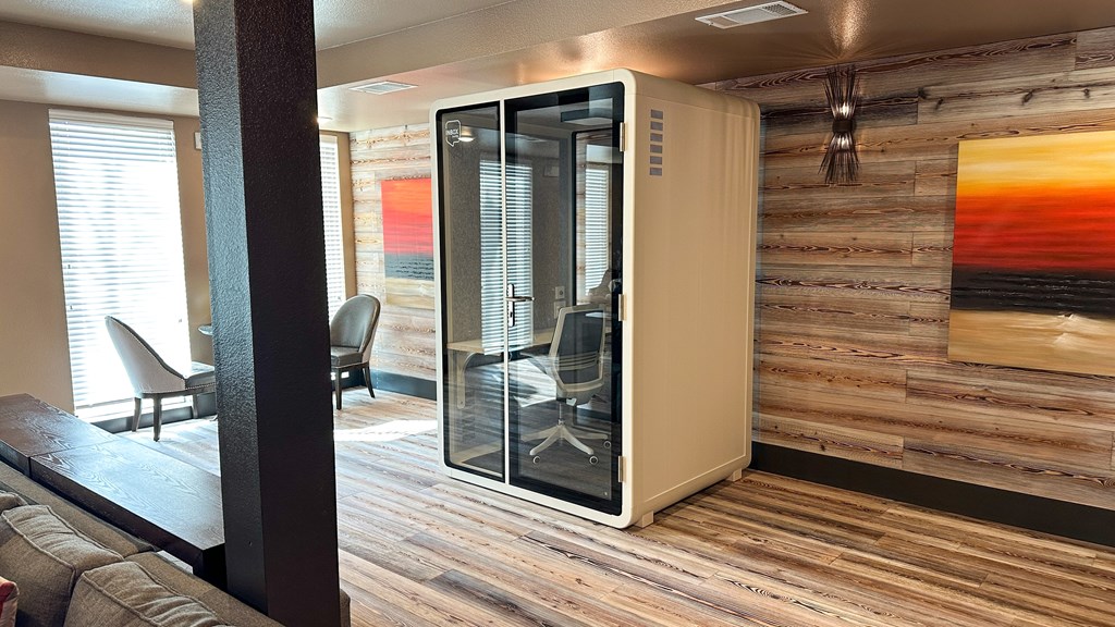 A room with a wooden wall and a glass door.