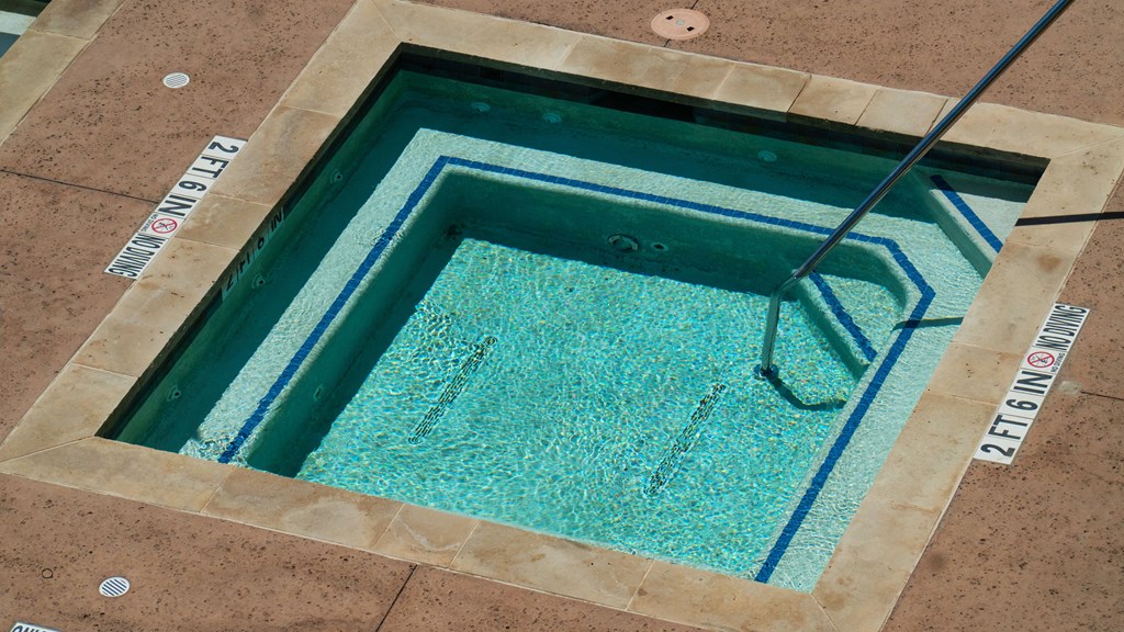 a hot tub with a ladder in the middle of it