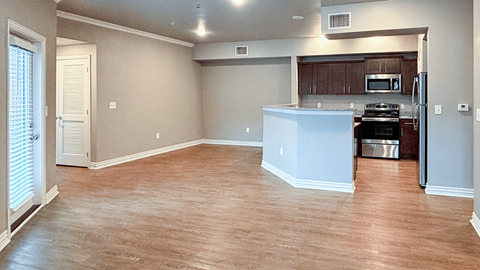 A kitchen area with a white refrigerator and a microwave.