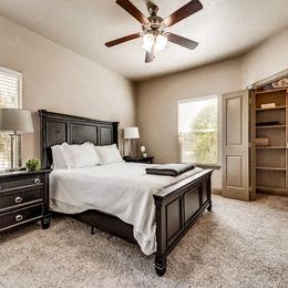 a bedroom with a bed and a ceiling fan