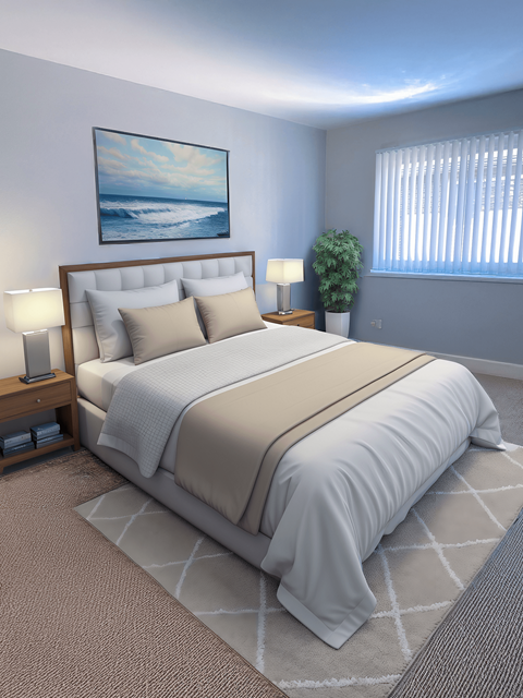 A bedroom with a large bed and a painting on the wall.