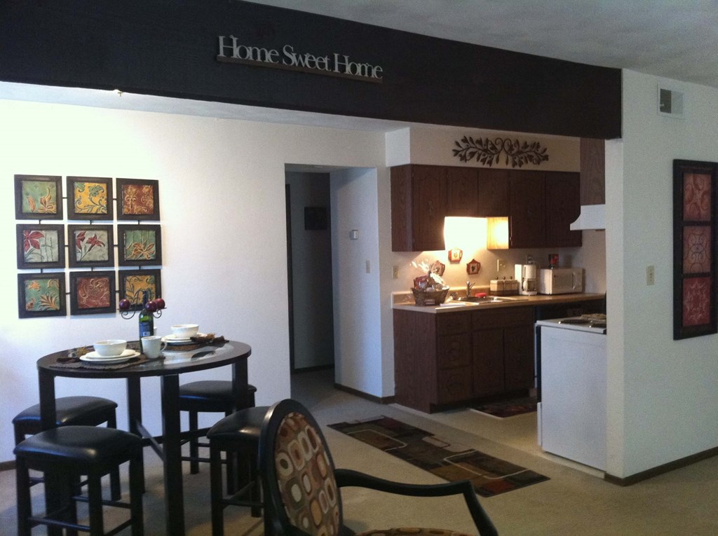 a kitchen and dining room with a table and chairs