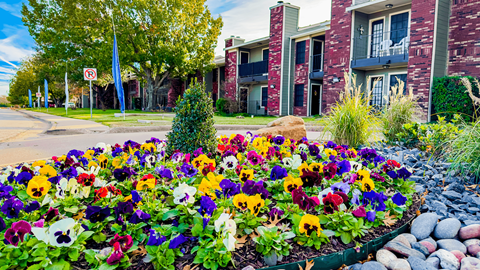 Flowers in the front of Townhouse apartments in ennis tx