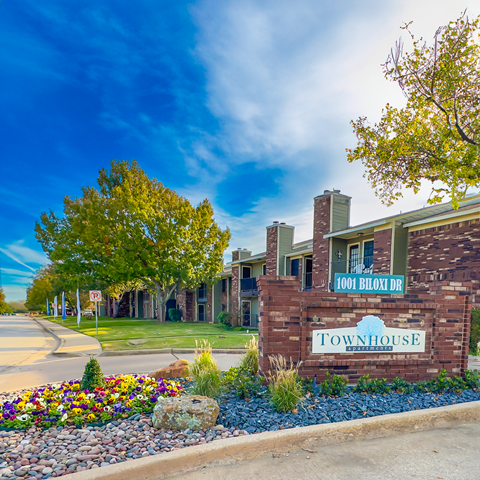 a brick building with a sign for townhouse  apartments