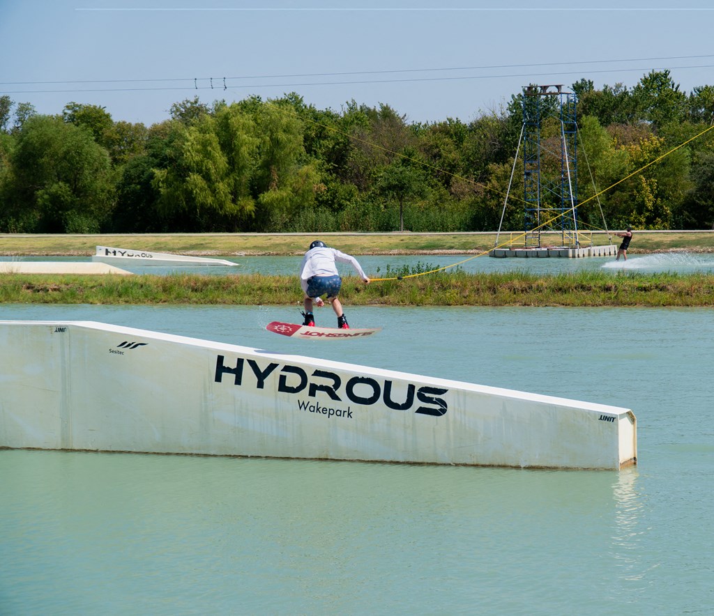 a skateboarder doing a trick on a ramp in the water