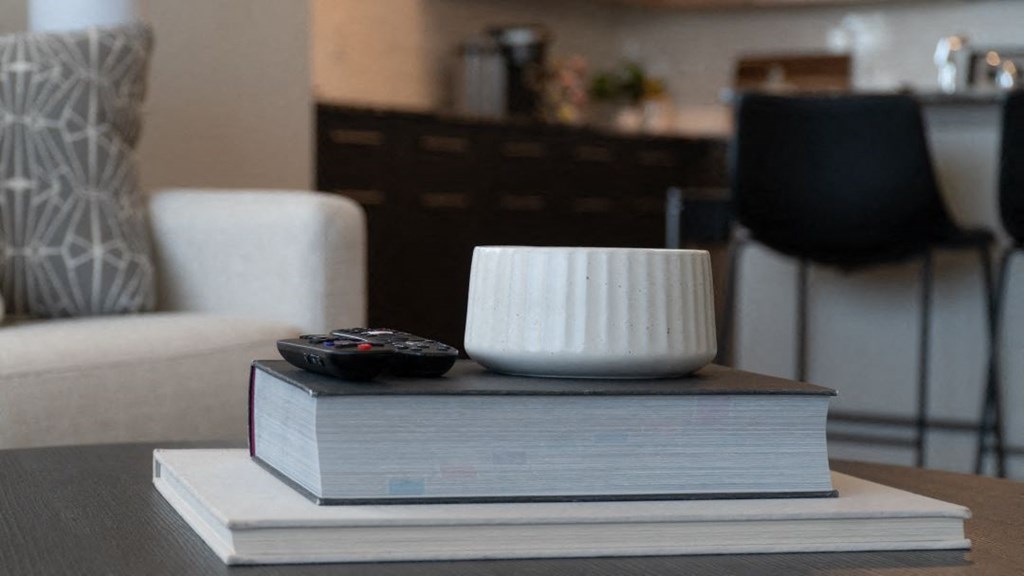 a book with a remote control and a bowl on top of it