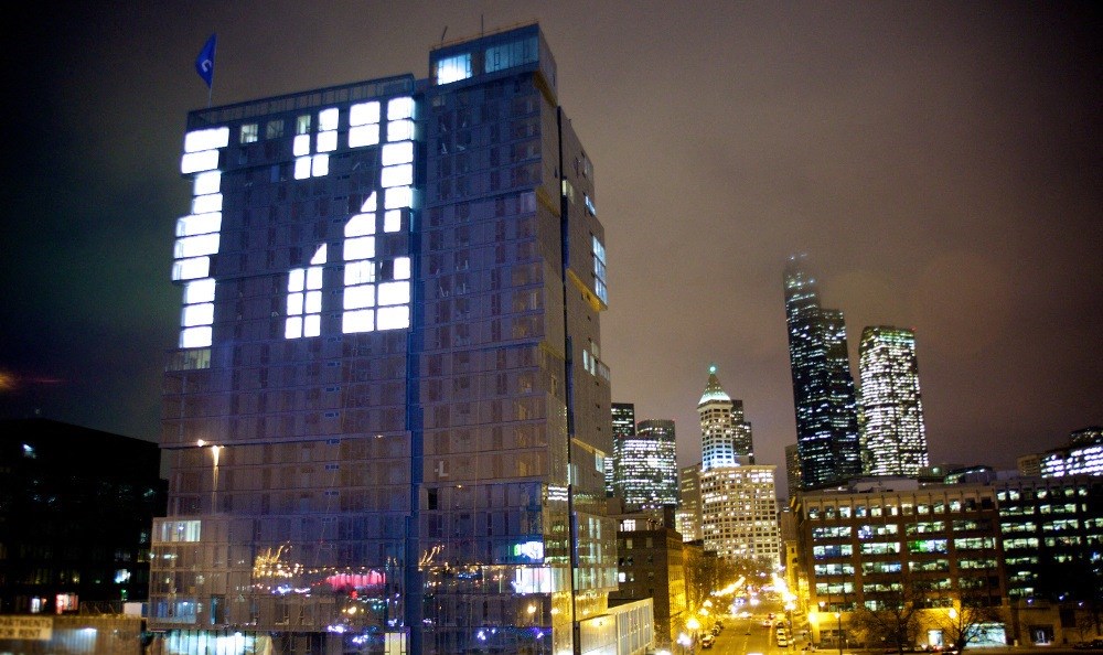 a view of the city at night with a large building with the