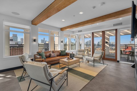 Bright living room with exposed wood beams at The Lyric Apartments, Washington, 98102