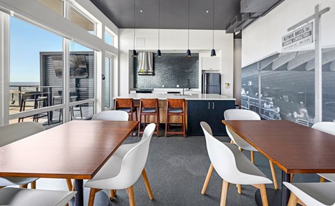 an entertaining area with a kitchen and table and chairs