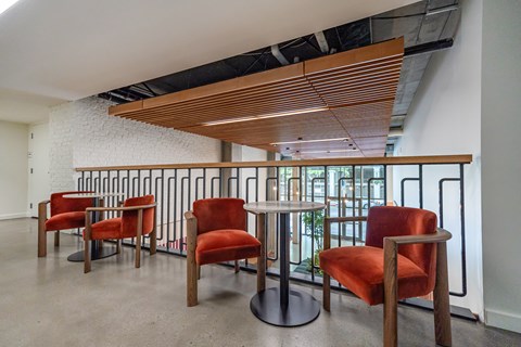 A row of red chairs are lined up in a row.