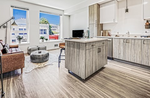 A kitchen with wooden cabinets and a large window.
