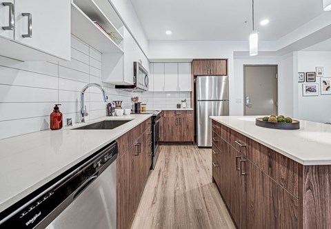 A modern kitchen with wooden cabinets and stainless steel appliances.