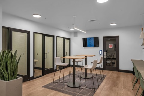 Collaborative workspace with high top table and privacy booths at The Lyric Apartments, Seattle, WA 98102