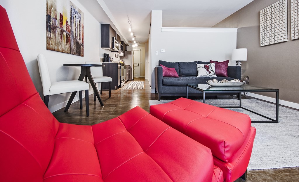 Living room facing kitchen and open bedroom