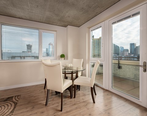a dining room with a table and chairs and sliding glass doors