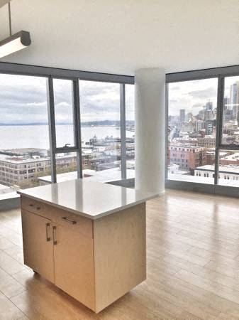 a kitchen with a island and a view of a city