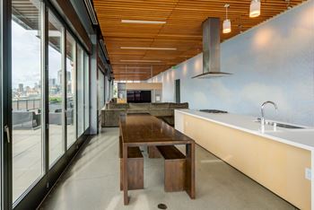 A modern kitchen with a wooden table and chairs.