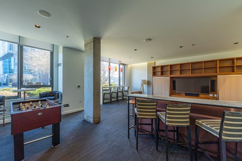 a living room with a bar and a foosball table