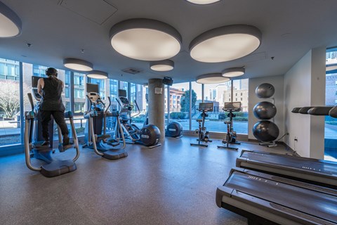 a woman exercising in a gym with cardio equipment