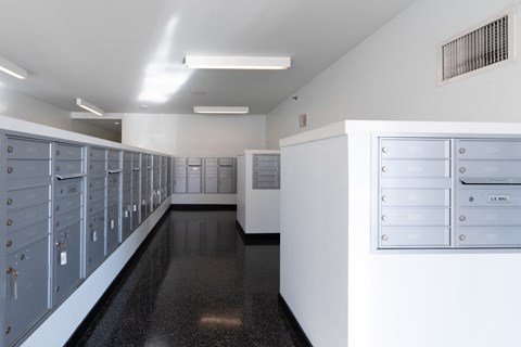 an empty locker room with a row of mailboxes