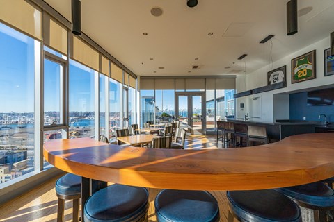 a dining room with a large wooden table and a view of the city
