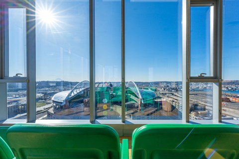 a view of a roller coaster from inside a bus with windows