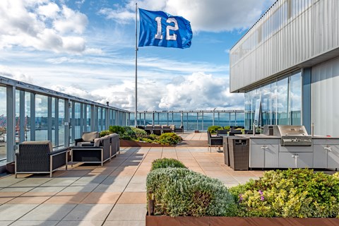 a rooftop patio with a flag and tables and chairs