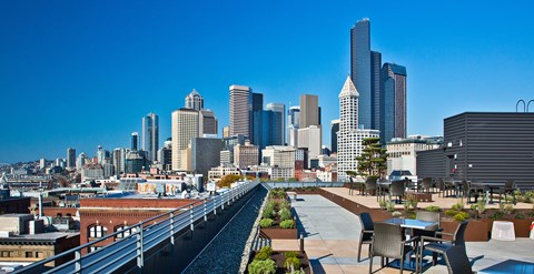 a rooftop terrace with a view of the city
