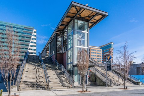 a modern building with stairs and a large glass elevator