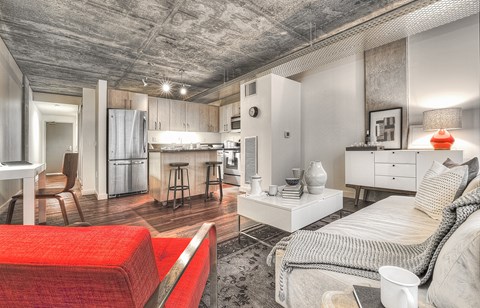 a living room with a couch and a kitchen in the background