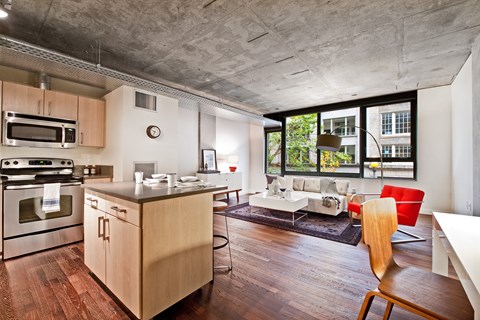 a living room with a kitchen and an open floor plan