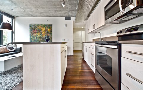 a kitchen with white cabinets and stainless steel appliances
