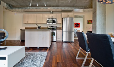a kitchen with white cabinets and a stainless steel refrigerator