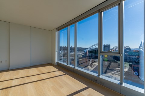 a living room with large windows and a view of a city